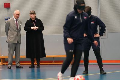 Charles watches on as college students play blind football