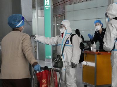 China reduces COVID-19 case number reporting as virus surges