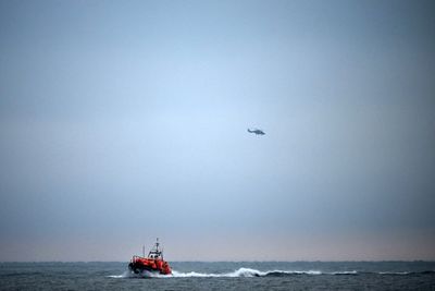 Four dead, dozens rescued from capsized boat in Channel