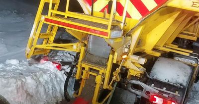 Gritter stuck in snow and pulled out by tractor after rescuing trapped driver