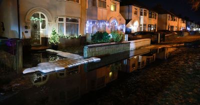 Burst water pipe closes road as people put out flood defences