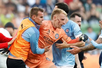 Melbourne derby abandoned as goalkeeper hit by metal bucket in ‘shocking scenes’