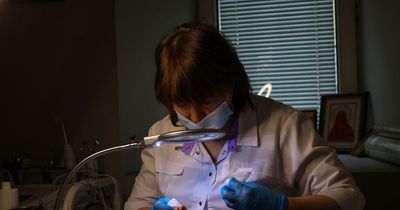 Ukrainian beauticians work under lamps using emergency bank as life continues despite war