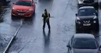 Steely Amazon delivery man filmed 'skiing' down icy road to get package to customer