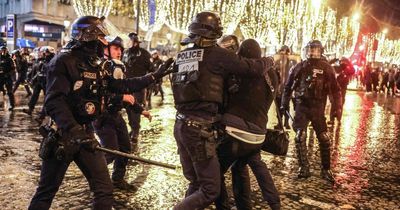 France fans riot in Paris after World Cup defeat as armed police pelt them with tear gas