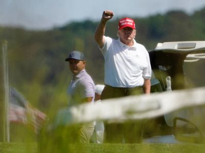 Trump aide rides along on golf cart with ex-president to show him positive news stories