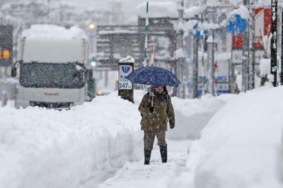 Snow piles deep in northern Japan, strands vehicles, 3 dead