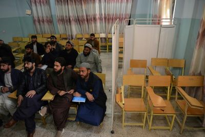 Armed guards stop Afghan women entering universities after Taliban ban