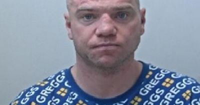 Man pictured wearing Greggs jumper in mugshot is being hunted by police