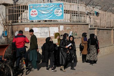 Afghan women weep as Taliban fighters enforce university ban