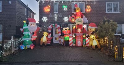 Family decorates home with thousands of Christmas lights and inflatables