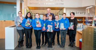 School pupils help to hand out bags of Christmas donations