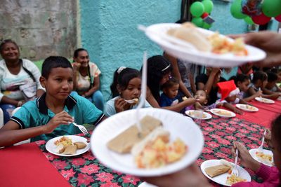 Venezuela's working-class communities get together to eat Christmas 'hallacas'