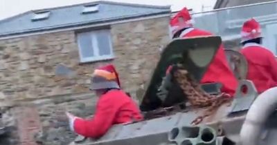 'Drunk' Santas in a tank cause chaos after getting stuck on narrow village road