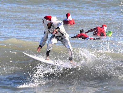 Frigid weather doesn't stop Santas surfing off Florida coast