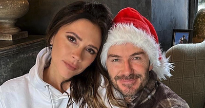 Loved-up Victoria Beckham sits on husband David's lap on most romantic Christmas ever