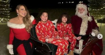 Mariah Carey and her twins get playful with Santa Claus at Christmas