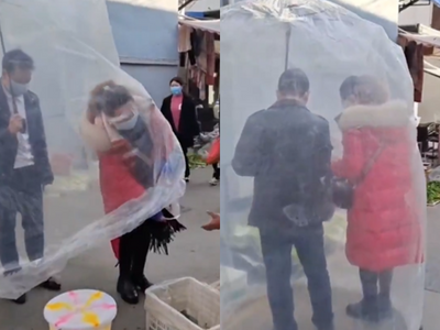 Chinese couple covers themselves innovatively with a big plastic sheet to avoid COVID; video goes viral