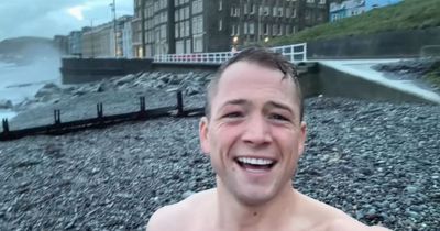 Taron Egerton braves Welsh sea swim and shares sweet family tradition as he comes home for Christmas