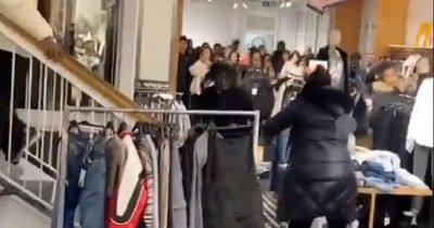 Boxing Day brawl as shoppers clash and grab metal clothing rail in mega fight over sales
