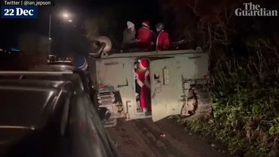 Santa Clauses Cause Chaos When Their Armored Vehicle Gets Stuck On Road