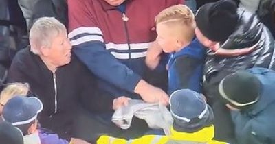 Newcastle supporter slammed for trying to snatch defender's shirt from the clutches of a young fan