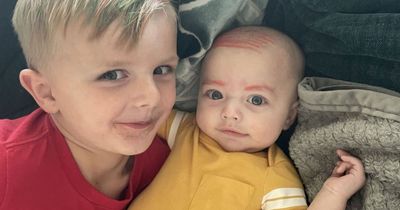 Boy draws eyebrows and combover on baby brother with orange pen so 'he's not left out'