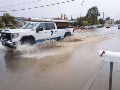 What is an atmospheric river, responsible for the heavy rainfall on the West Coast?