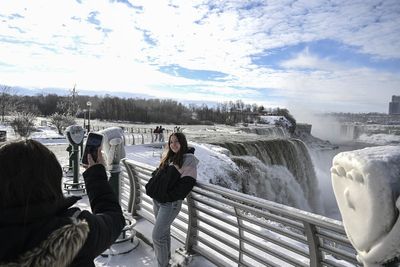 Tourists flock to frozen Niagara Falls as Buffalo’s devastating storm death toll continues to climb