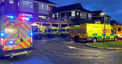 At least TEN ambulances pictured waiting outside 'extremely busy' Greater Manchester hospital as trusts across the region warn of long waits