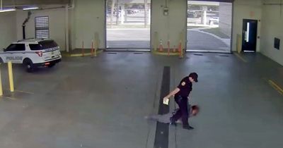 Police officer caught on camera dragging handcuffed woman across concrete floor