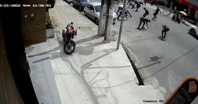 Locals rush to scoop up cash dropped by clumsy robbers following lottery shop raid