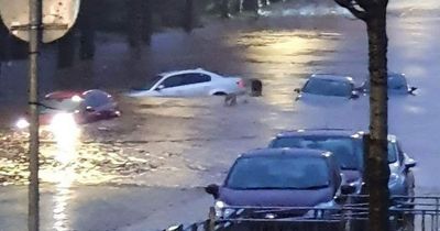 Cars floating down street as torrential downpour causes severe flooding