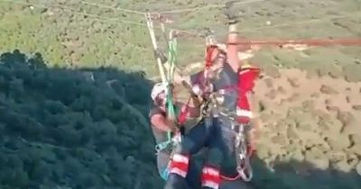 Nail-biting moment firefighters save woman from 200ft zip line drop