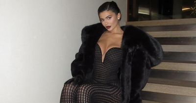 Kylie Jenner rings in New Year in extreme cleavage baring catsuit with celeb pals