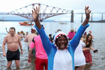 Thousands join London’s New Year’s Day parade as swimmers brave icy waters