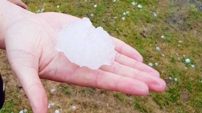 Large hail stones damage cars as severe storms cross Tasmania
