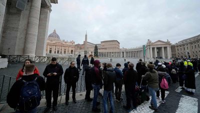 Tens of thousands view Pope Benedict lying in state at Vatican