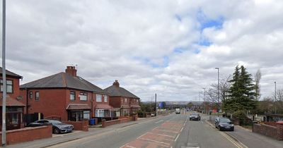 Police and paramedics at scene of motorcycle crash on main road