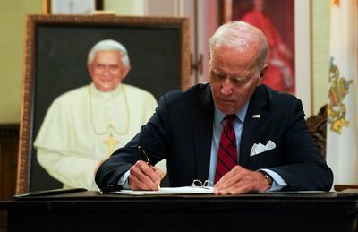 Biden signs condolences for former Pope Benedict in Washington