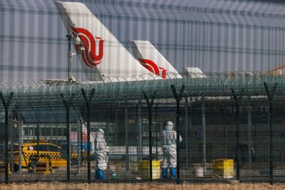 Travel curbs rack up as COVID-hit China readies reopening