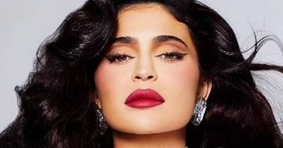 Kylie Jenner vamps it up with a glam pout and clinging white dress for Kylie Cosmetics