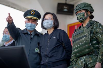 Taiwan's Tsai visits base as China protests US ship passage