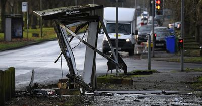 Car crashes and bursts into flames on busy road leaving wreckage at bus stop