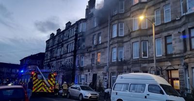 Flat fire in Ibrox as woman rushed to hospital and thick black smoke seen billowing from windows