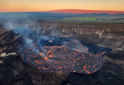 Hawaii volcano eruption continues as alert level lowered
