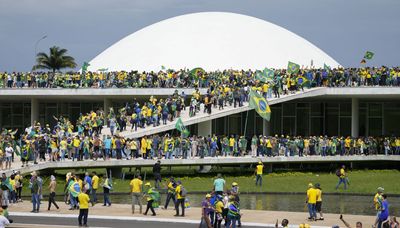 Protesters backing former Brazilian president storm legislature, high court, presidential palace