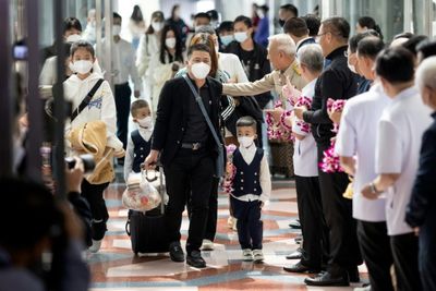 Flowers and face masks as Chinese tourists return to Thailand