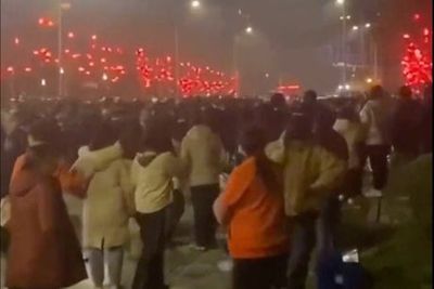 Chinese official says ‘90% of province infected with Covid’ as test workers clash with police