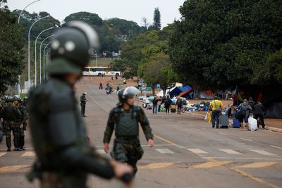 Brazilian police gather at camp of Bolsonaro supporters in capital Brasilia - Reuters witness